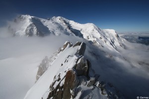 Au premier plan, la crête des cosmiques. Au fond de gauche à droite : le Mont Blanc du Tacul, le Mont Maudit, le Mont Blanc (4810 m), le dôme et l'Aiguille du Gouter.  Photo et commentaire : Laurent Gernez.